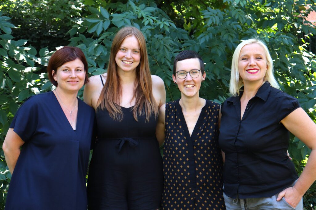 Vier Frauen vor einem grünen Hintergrund